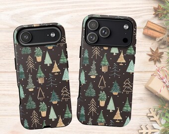 May include: Two black smartphone cases featuring a repeating pattern of various stylized Christmas trees in shades of green, gold, and white, interspersed with small white dots resembling falling snow across the entire surface.