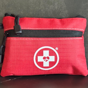 Tier One Essentials – Compact First Aid Kit | Emergency Travel Safety Kit | Fully Stocked Red Bag