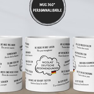 May include: White ceramic mug with black text and illustrations. The mug features German phrases and the text "MUG 360° PERSONNALISABLE". The mug has a handle and is designed for hot beverages.