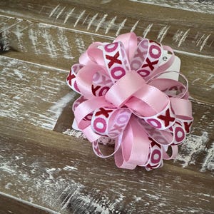 Valentine loopy puffer bow hair tie White ribbon printed with red glitter X’s and pink glitter O’s and coordinating pink satin ribbon