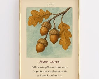 May include: Framed art print featuring a watercolor illustration of acorns and oak leaves in shades of brown and gold. The text "Autumn Acorns" is displayed below the image, with additional handwritten text. The frame is gold.