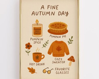 May include: A framed print with a gold border featuring autumn-themed illustrations. The text "A Fine Autumn Day" is at the top. Illustrations include a pumpkin spice candle, pumpkin pie, a cozy sweater, hot drink, glasses, and a mushroom.