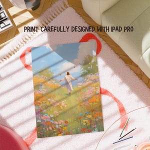 May include: A print featuring a person in a white robe walking through a field of colorful flowers. The artwork is set against a blue sky with clouds. Text at the top reads "PRINT CAREFULLY DESIGNED WITH IPAD PRO". The print is on a pink rug.