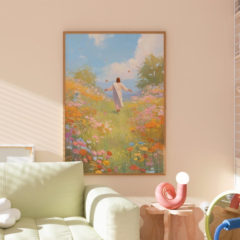 May include: A framed art print depicts a person in a white robe walking through a vibrant field of wildflowers. The artwork features a bright blue sky with fluffy clouds and a warm color palette of yellows, oranges, pinks, and greens.