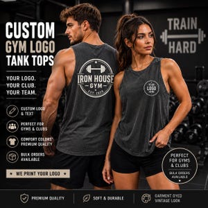 May include: Two charcoal gray tank tops featuring custom logo printing. The back of one tank top displays a circular Iron House Gym logo with a barbell icon, while the other shows a small circular logo on the chest. Text includes Custom Gym Logo Tank Tops, Your Logo, Your Club, Your Team, and Train Hard.