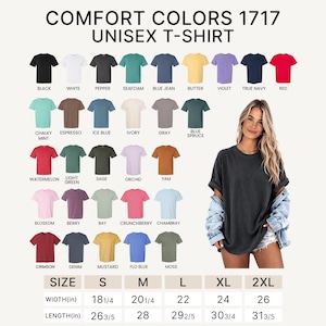 May include: A Comfort Colors 1717 unisex t-shirt in various colors, including black, white, and red. The image displays a woman wearing a dark gray t-shirt. Size chart shows width from 18 1/4 inches to 26 inches and length from 26 3/5 inches to 31 3/5 inches.