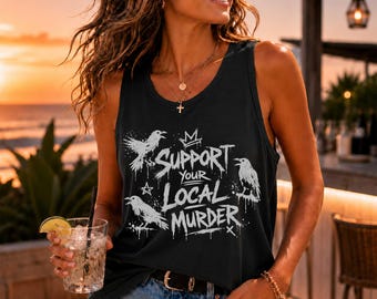 May include: A black sleeveless tank top featuring a white graphic print of three ravens and the text SUPPORT YOUR LOCAL MURDER. The design includes a small star and crown icon, with a distressed, splattered ink effect across the front of the garment.