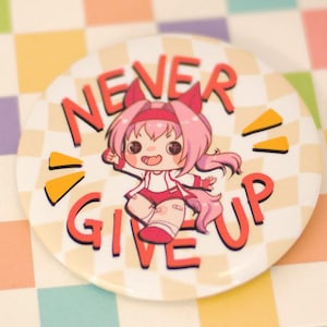 May include: A round button with the words "NEVER GIVE UP" in red and orange. The button features a cartoon character with pink hair and a matching outfit. The background is a colorful checkered pattern.