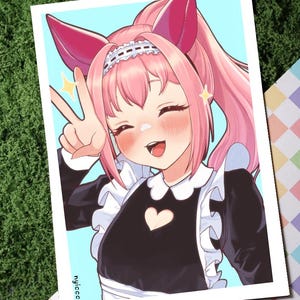 May include: Illustration of a smiling anime character with pink hair and cat ears, wearing a black maid outfit with a white collar and heart detail. The character is giving a peace sign. The background is light blue.