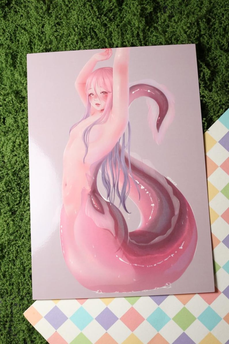 May include: A print featuring a nude figure with pink hair and a pink and purple tail. The figure's arms are raised above their head. The artwork has a soft, illustrative style with a light pink background.