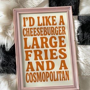 funny kitchen wall art with cheeseburger fries and cosmopolitan quote in bold retro typography