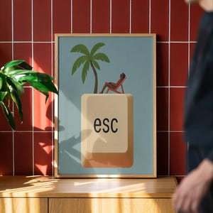 Minimalist ESC key wall art poster with a palm tree and lounging figure design in a wooden frame, displayed against a red tiled wall with natural light, modern office decor and tech-inspired home print.