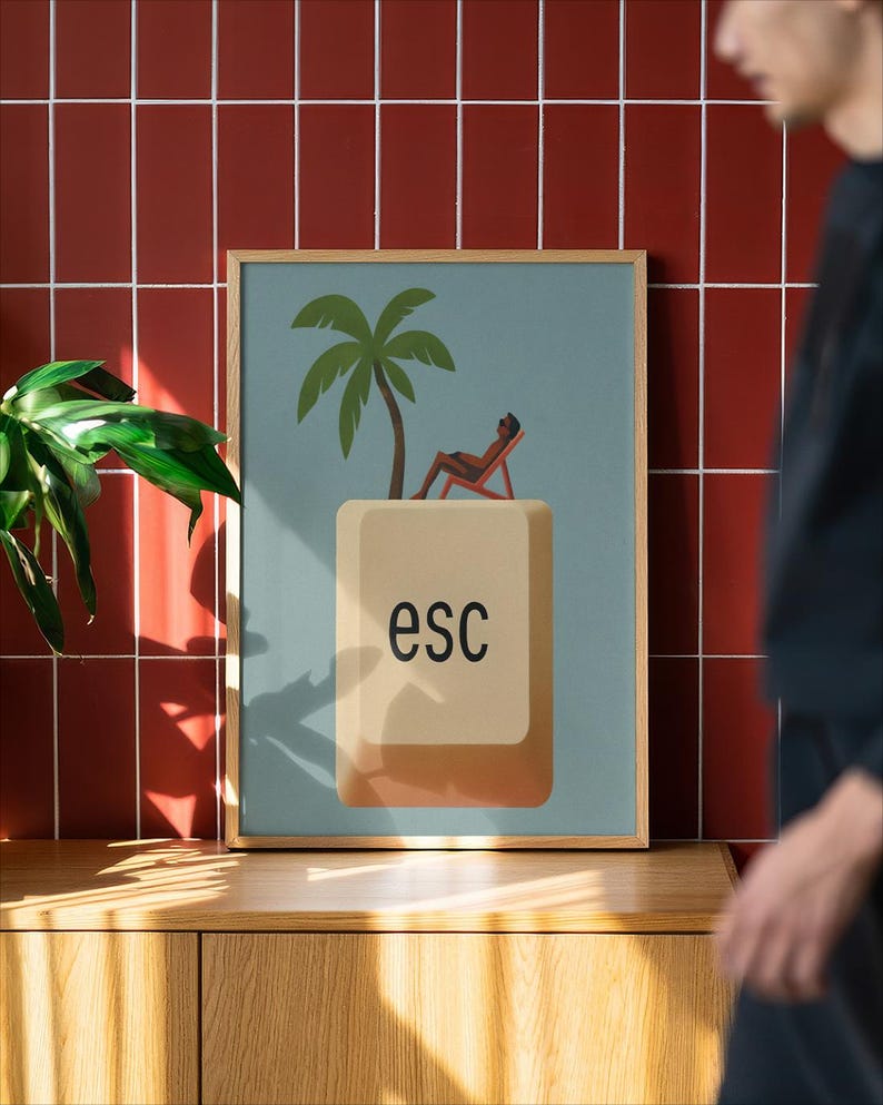 Minimalist ESC key wall art poster with a palm tree and lounging figure design in a wooden frame, displayed against a red tiled wall with natural light, modern office decor and tech-inspired home print.