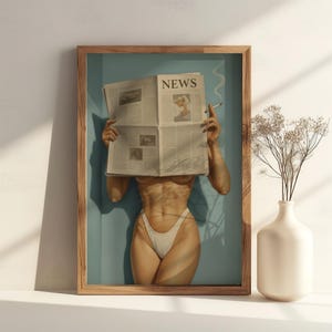 May include: A framed art print featuring a person holding a newspaper with the headline "NEWS" in front of their face. The person is wearing a white bikini bottom. A lit cigarette is held in one hand. A vase with dried flowers is on the right.