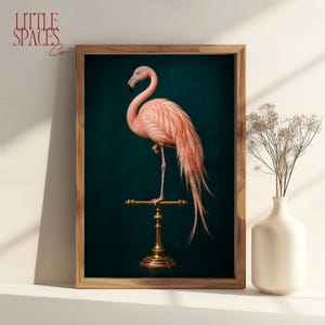 May include: A framed wall art print featuring a pink flamingo standing on a gold-coloured metal perch against a dark teal background. The flamingo has long, flowing tail feathers and is positioned in profile. The frame is made of light-coloured wood.