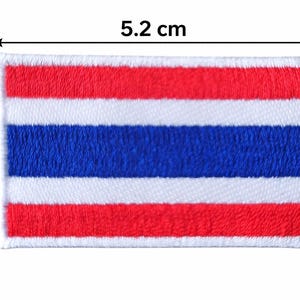 May include: Embroidered patch depicting the flag of Thailand. The rectangular patch measures 5.2 cm by 3.1 cm, with horizontal stripes of red, white, and blue. The patch has a white border.