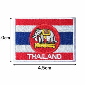 May include: Embroidered patch featuring the flag of Thailand, measuring 4.5cm wide and 3.0cm high. The design includes red, white, and blue stripes, a central emblem of an elephant, and the word "THAILAND".