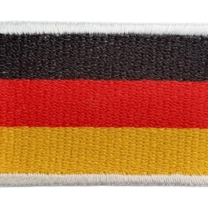 May include: A black, red, and yellow embroidered German flag patch with a white border.