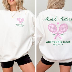 May include: White sweatshirt with a pink tennis racket graphic and the text "Match Setters" and "ACE TENNIS CLUB". The back of the sweatshirt features the text "Match Setters", a tennis ball, crossed rackets, and "ACE TENNIS CLUB, AUSTIN, TX".