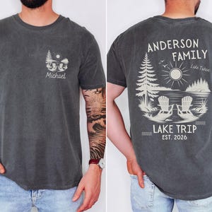 May include: A charcoal grey t-shirt featuring a small graphic on the front left chest with the name Michael and a lake scene. The back displays a large graphic with the text Anderson Family, Lake Tahoe, Lake Trip, and Est. 2026.