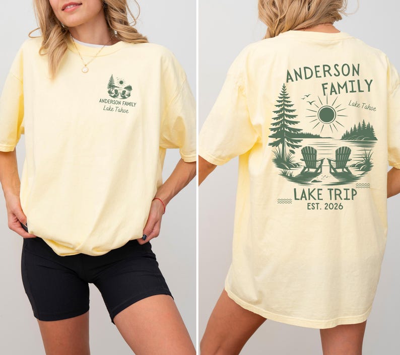 May include: A pale yellow short-sleeve t-shirt featuring a dark green graphic of two chairs by a lake with pine trees and the sun. The front chest displays a small version of the design, while the back features the text Anderson Family Lake Trip Est. 2026.