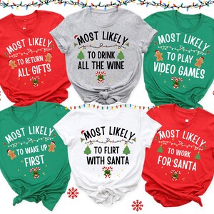 May include: A collection of six short-sleeved t-shirts in red, gray, green, and white. Each shirt features the text MOST LIKELY followed by unique phrases like TO RETURN ALL GIFTS, TO DRINK ALL THE WINE, TO PLAY VIDEO GAMES, TO WAKE UP FIRST, TO FLIRT WITH SANTA, or TO WORK FOR SANTA, accented with gingerbread men, Christmas trees, and candy canes.