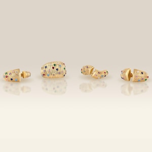 Lifestyle view of the multi-color cubic zirconia fluted dome rings styled naturally on a hand against a soft-focus background.