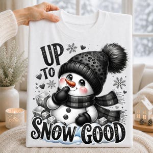 White t-shirt featuring a monochrome black and gray snowman with winter hat, scarf, snowflakes and Up to Snow Good lettering