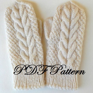 May include: A pair of cream-colored knitted mittens with a cable knit pattern. The mittens have a ribbed cuff and are made with a soft yarn.