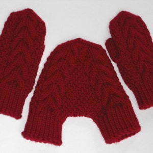 May include: A set of red knitted mittens and a matching hat. The mittens and hat have a cable knit pattern.