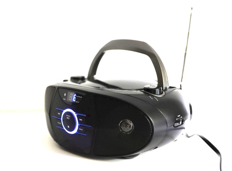 May include: Black portable boombox with a handle and extendable antenna. The radio has a digital display and blue illuminated buttons. The speaker has a mesh grill. The boombox is on a white background.