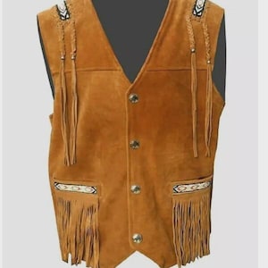 May include: A tan suede vest with a V-neck and three button closure. The vest features decorative fringe along the bottom and shoulder accents with beaded details. Braided leather tassels hang from the shoulders and chest pockets.