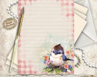 May include: A stationery set featuring a lined paper with a pink gingham border and a watercolor illustration of a blue bird perched on flowers. Includes envelopes, a pen, and a digital download tag. The paper size is 5.8 x 8.3 inches.