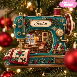 May include: A teal sewing machine ornament featuring gold snowflake accents, red holly berries, and a quilted fabric piece with poinsettia patterns. The centre displays a miniature room scene with a cat and a sign reading Jessica in script.