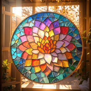 May include: A round stained glass window featuring a floral design with a gold metal frame. The flower has petals in shades of orange, yellow, pink, and white. The background is a mosaic of blue, green, and purple glass.