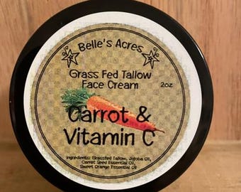 May include: A black jar with a white label that reads "Belle's Acres Grass Fed Tallow Face Cream Carrot & Vitamin C 2oz". The label also lists the ingredients: "Grassfed Tallow, Jojoba Oil, Carrot Seed Essential Oil, Sweet Orange Essential Oil".