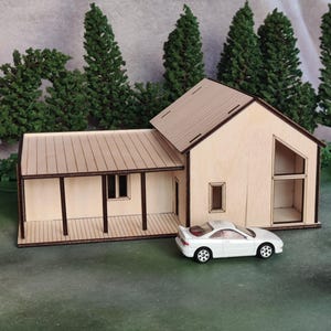 May include: A white ceramic mug with a black handle and the text "But First, Coffee" in a bold, black font. The mug is on a white surface. The mug is approximately 4 inches tall.