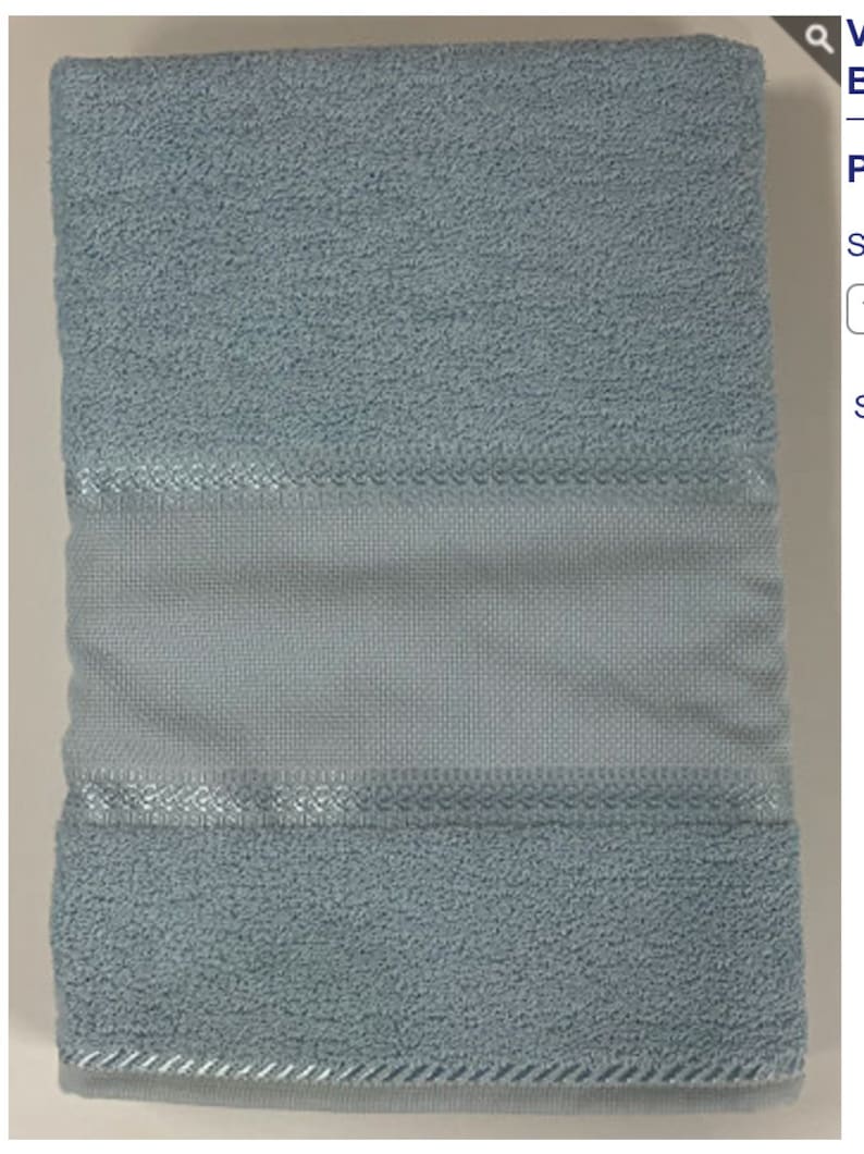 May include: A light blue bath towel with a white border and a subtle sheen. The towel is folded in half and has a soft, fluffy texture.