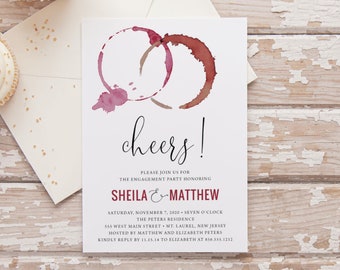 May include: A white card with a red wine glass stain design. The text "cheers!" is written in black cursive font. The card is an engagement party invitation for Sheila and Matthew. The invitation includes the date, time, location, and RSVP information.