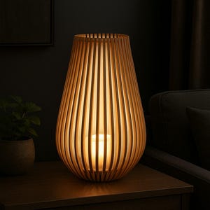 May include: A wooden table lamp with a warm, inviting glow. The lamp has a unique design, with vertical wooden slats forming a rounded, vase-like shape. The lamp is sitting on a dark wooden table.