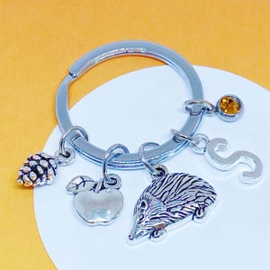 Llavero de erizo personalizado con dije de manzana, piña y piedra natal - K-MIX-AG006-10-AG014-1-AG016-2