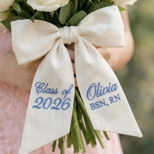 May include: A set of three ceramic mugs with a speckled, matte finish. The mugs are in shades of cream, light gray, and dark gray. Each mug has a simple, minimalist design and a rounded handle. The mugs are stacked on top of each other.