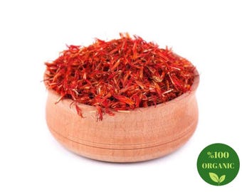 May include: A wooden bowl filled with dried red safflower petals. The bowl is on a white background. The text "100% Organic" is printed on a green circle with a leaf design.
