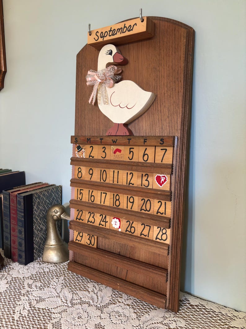 Wooden perpetual goose calendar styled in a warm vintage-inspired room