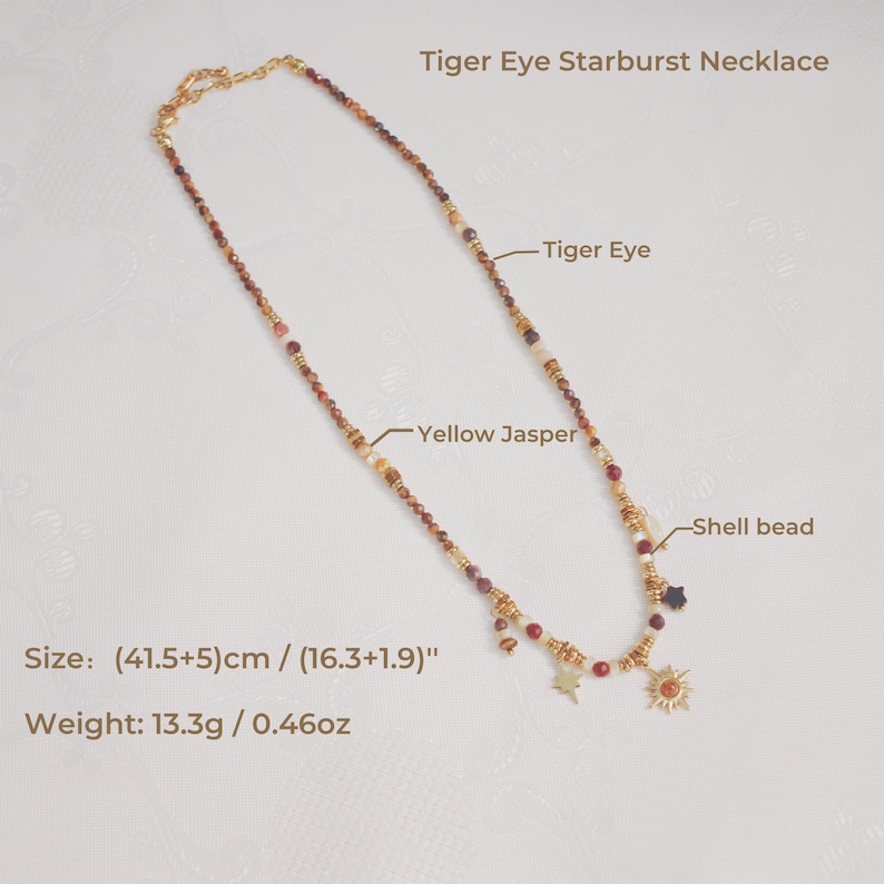 May include: A Tiger Eye Starburst Necklace featuring Tiger Eye, Yellow Jasper, and shell beads. The necklace includes gold-toned star and sun charms. The text indicates a size of (41.5+5) cm / (16.3+1.9) inches and a weight of 13.3g / 0.46oz.