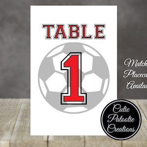 May include: White table number card with a black and gray soccer ball graphic and the number 1 in red. The text "TABLE" is in red and black letters. The text "Matching Placecards Available" is in black.