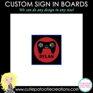 May include: A red and black sign in board with a video game controller graphic and the name "DYLAN" in black text. The sign in board is surrounded by a blue border.