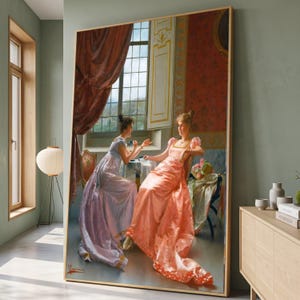 May include: A large framed wall art print depicting a classical painting of two individuals in long gowns, one in light purple and one in peach, seated in a room with a window, red curtains, and patterned wallpaper, displayed in a modern interior.