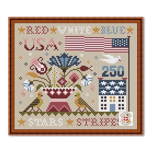 May include: Cross-stitch design in a wooden frame featuring patriotic elements. The design includes an American flag, floral arrangements, birds, and the text "USA", "Stars", "Stripes", and "250". The color palette includes red, white, and blue.
