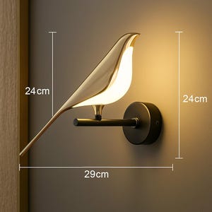 May include: A gold bird-shaped wall light fixture with a black base. The light is 29 inches wide, 24 inches tall, and 24 inches deep.